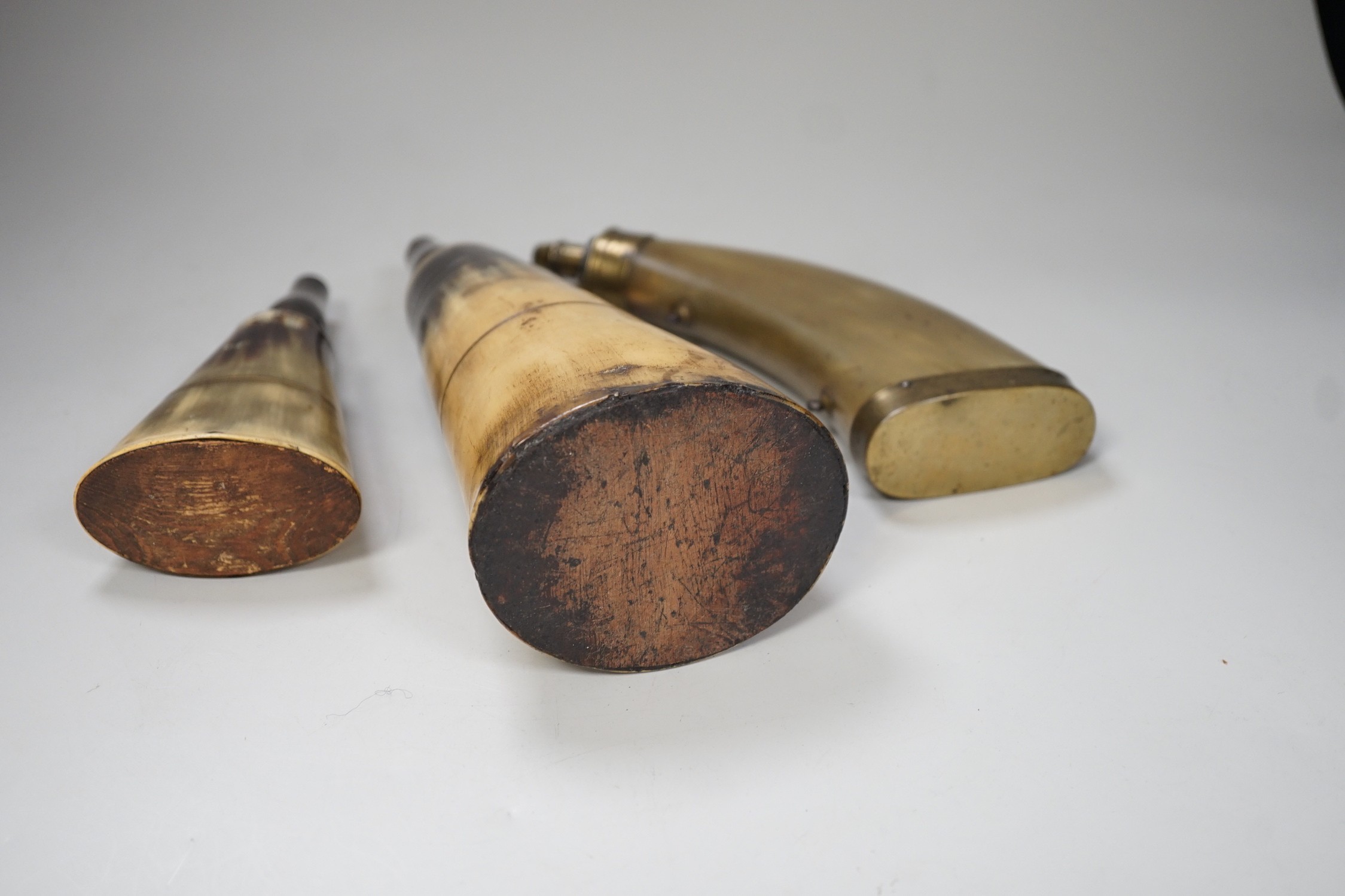 Three various 19th century horn flasks/beakers. Largest 25cm wide